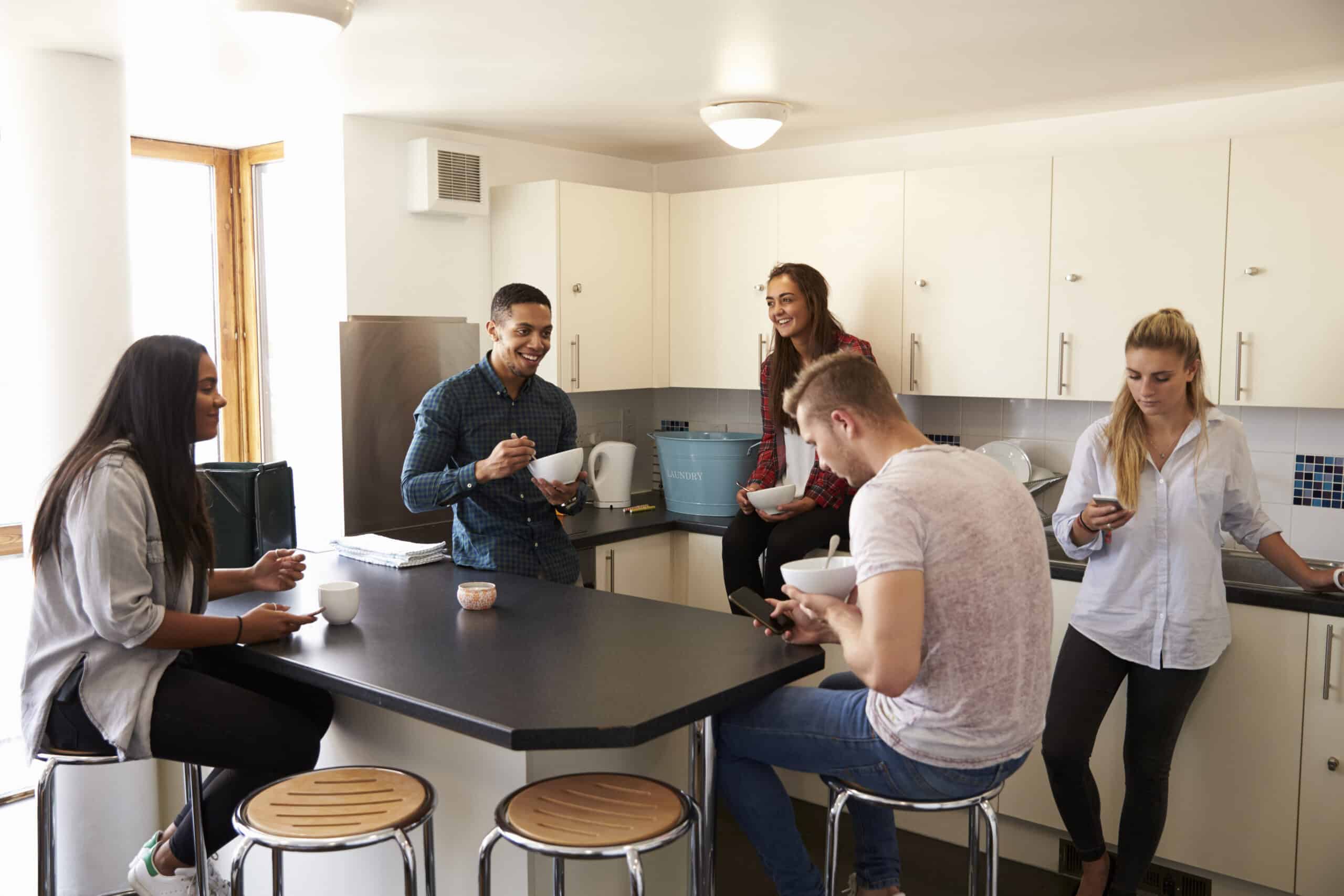 Students gathered in the kitchen of a HMO.
